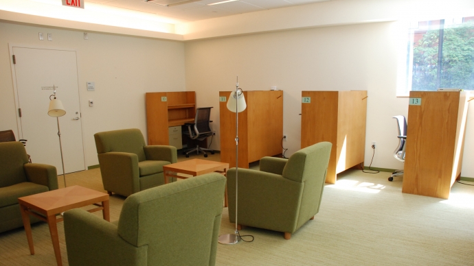 study carrels in a sunlit room emptied of people