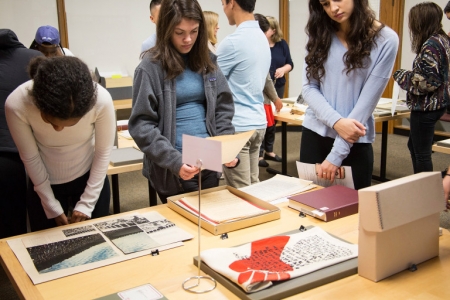 Students examine materials in the Archives as part of a class. 