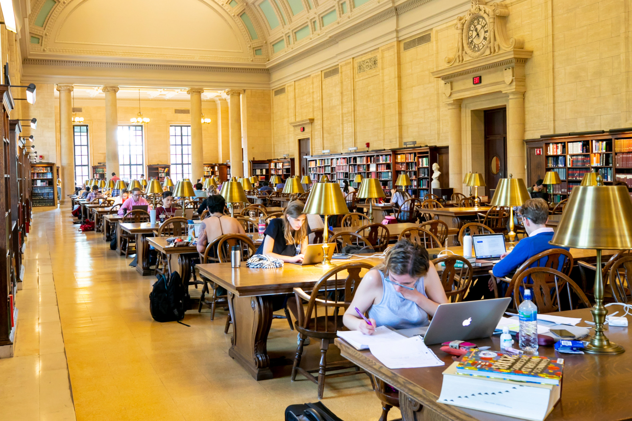 Students study at desks in the Loker Reading Room of Widener Library.