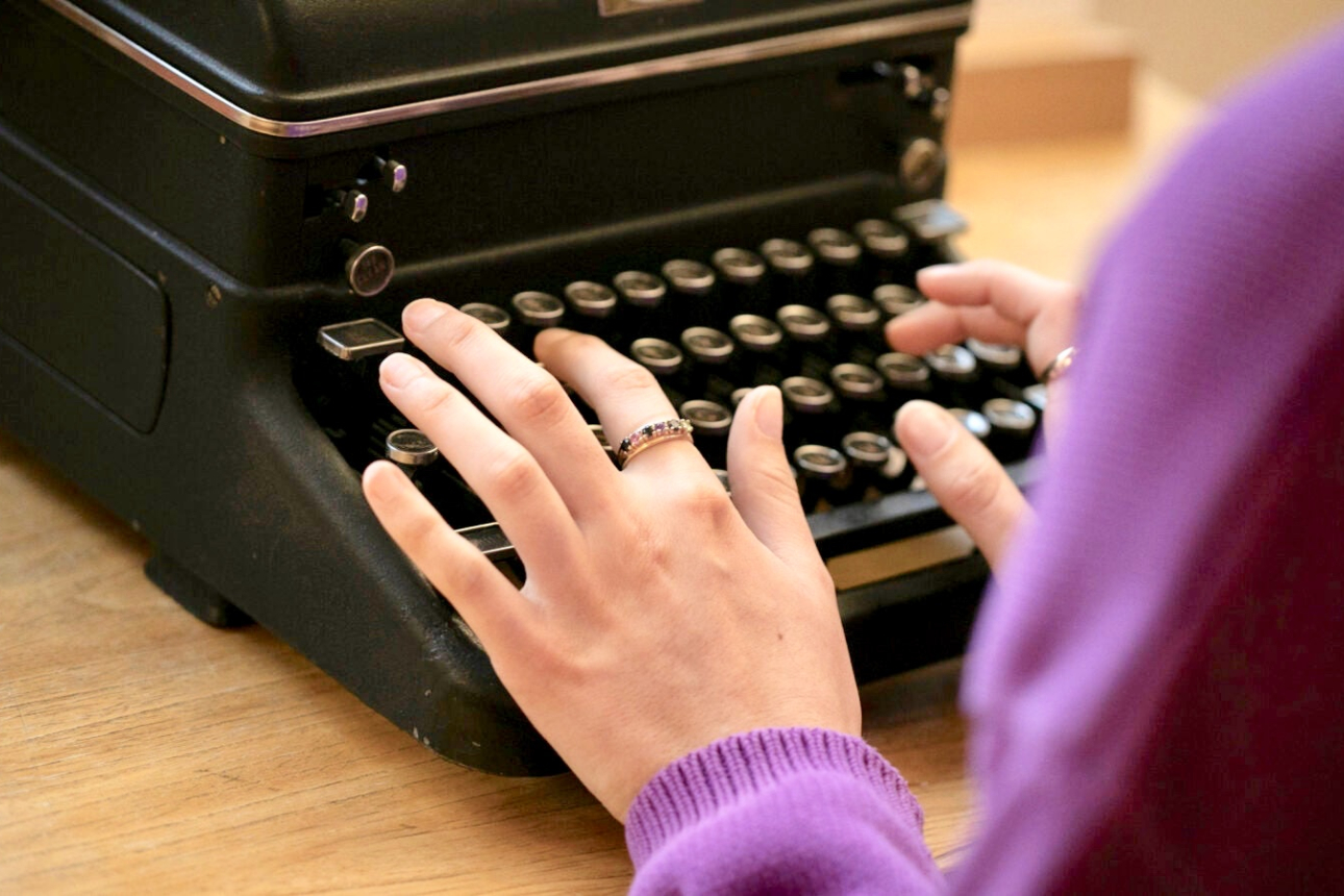Hands typing on Ashbery typewriter