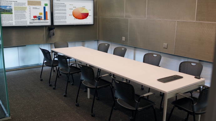 Video Conferencing Room with a long table and chairs around it