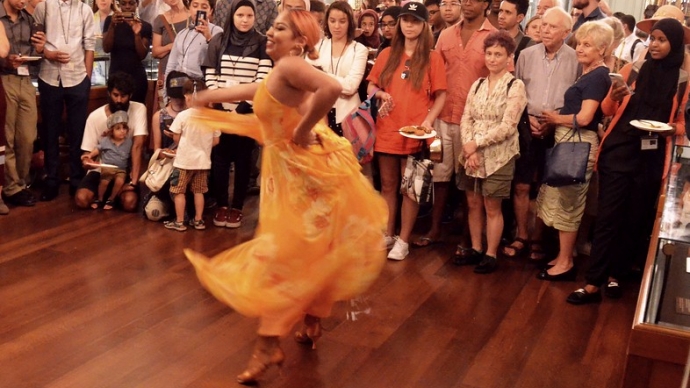 An event at Houghton Library in which an individual dances in the cleared-out center of a crowd of people