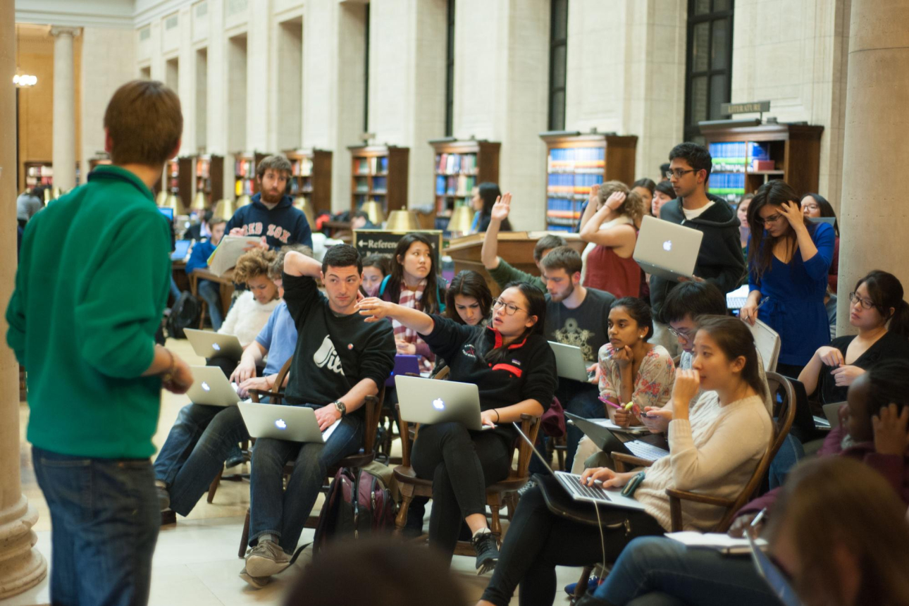 Students participate in CS50 office hours in the library.