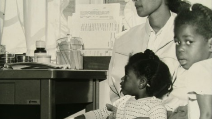 Black woman with two children sitting in doctor's office