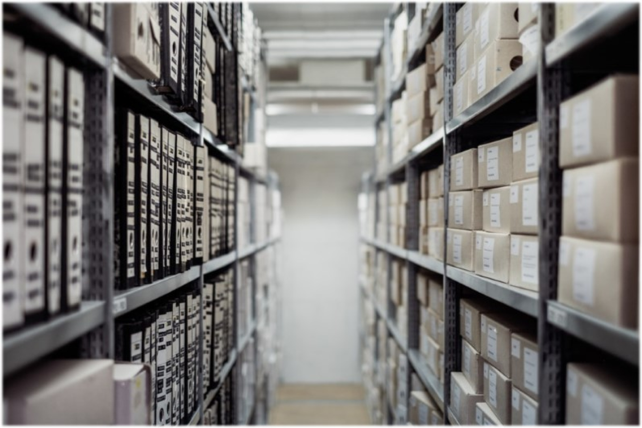 view down aisle with shelves of archival boxes and file storage