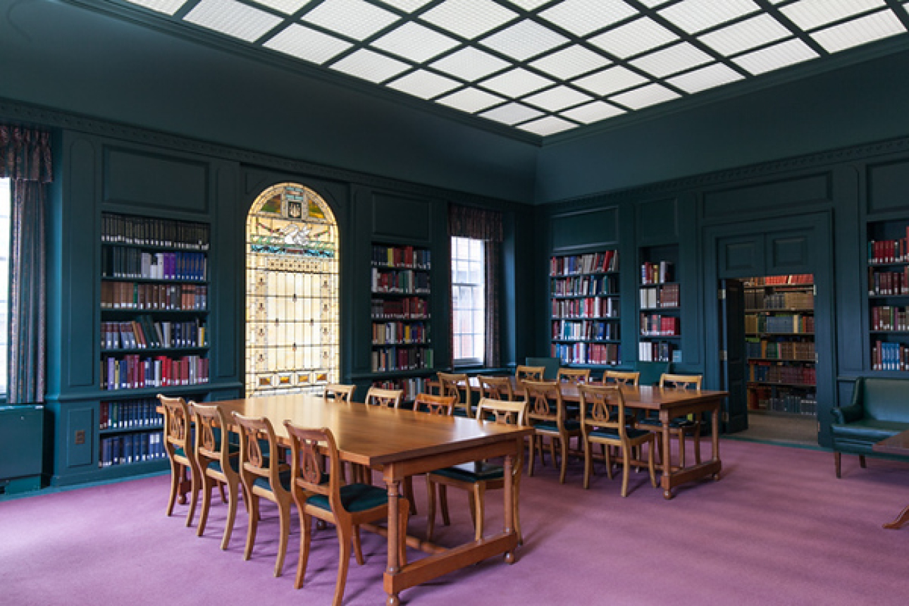 The Loeb Spalding Room at the Music Library, featuring big desks with many chairs as well as open book shelves