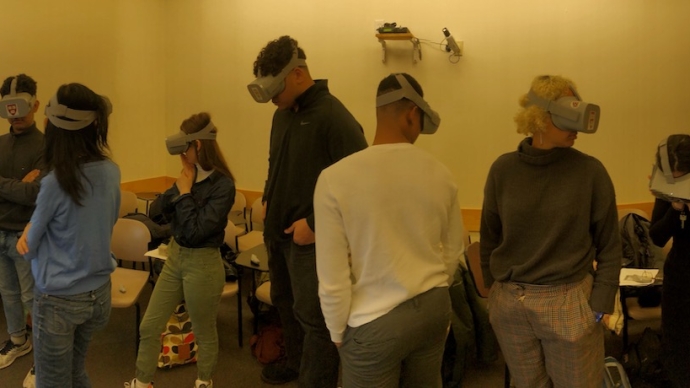 Panorama of students wearing VR headsets in a classroom
