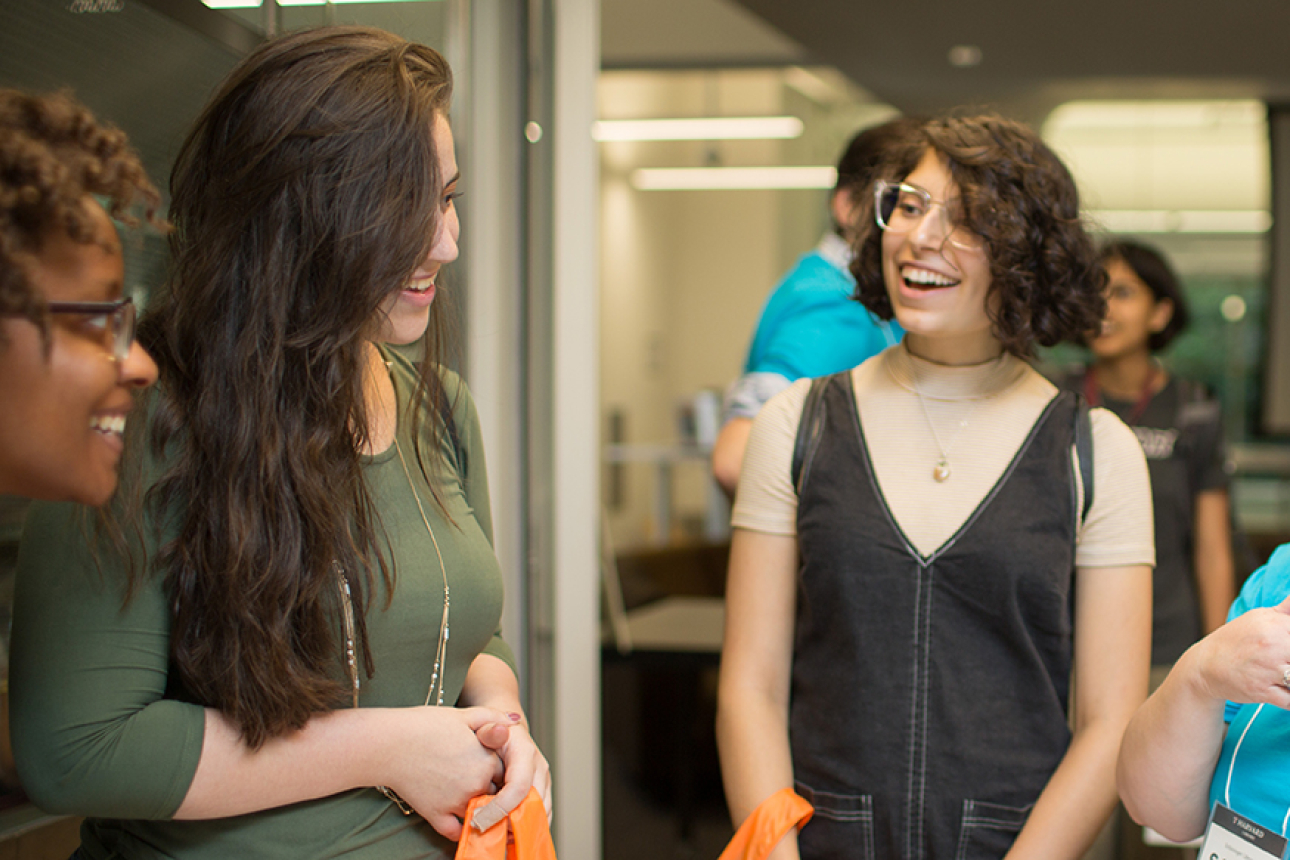 Librarian talking with students at Open House