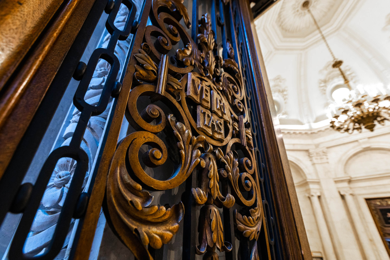 A detailed view of a door inside widener library feature the Harvard shield 
