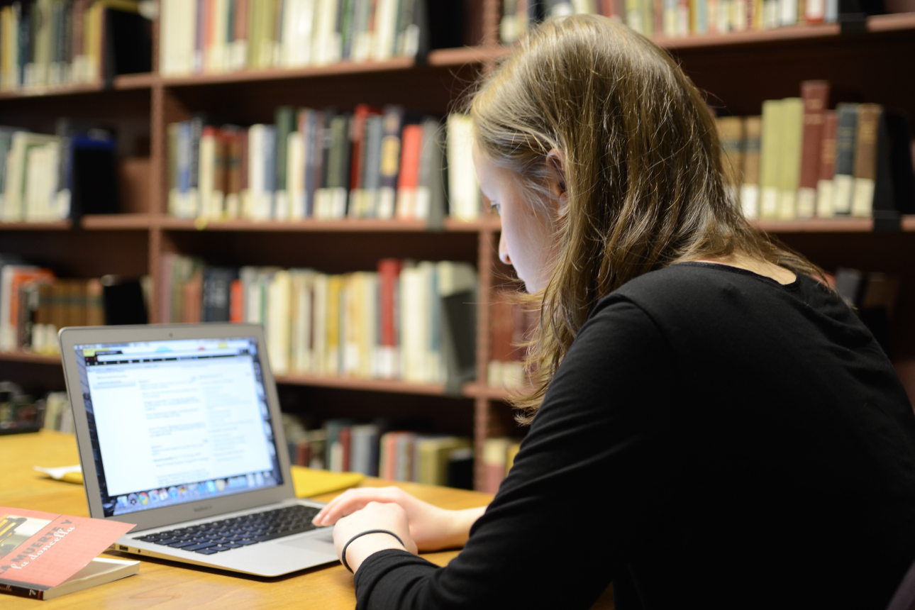Student working on laptop in Lamont Library