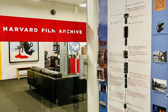 a view of the HFA film timeline poster next to the glass door of the offices