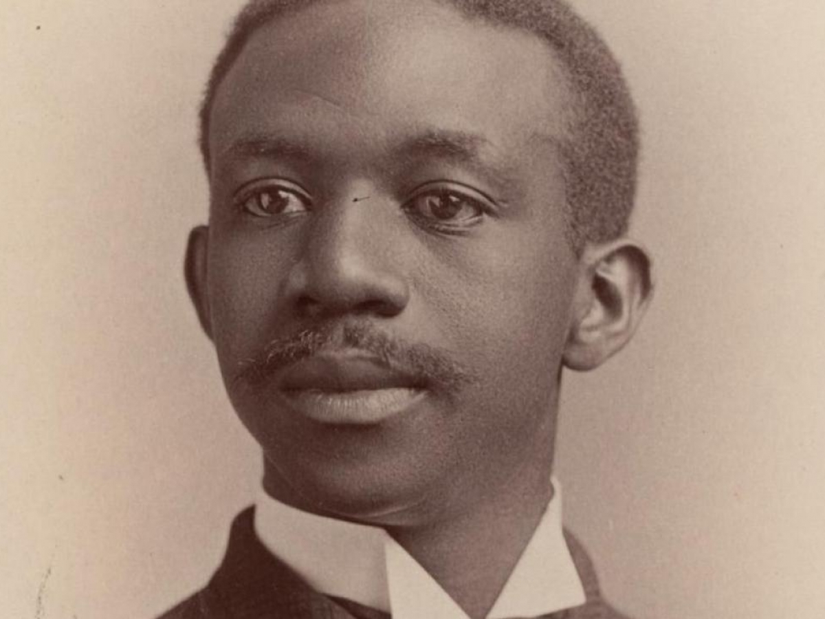 A young man sits for a portrait. He is photographed from the neck up.
