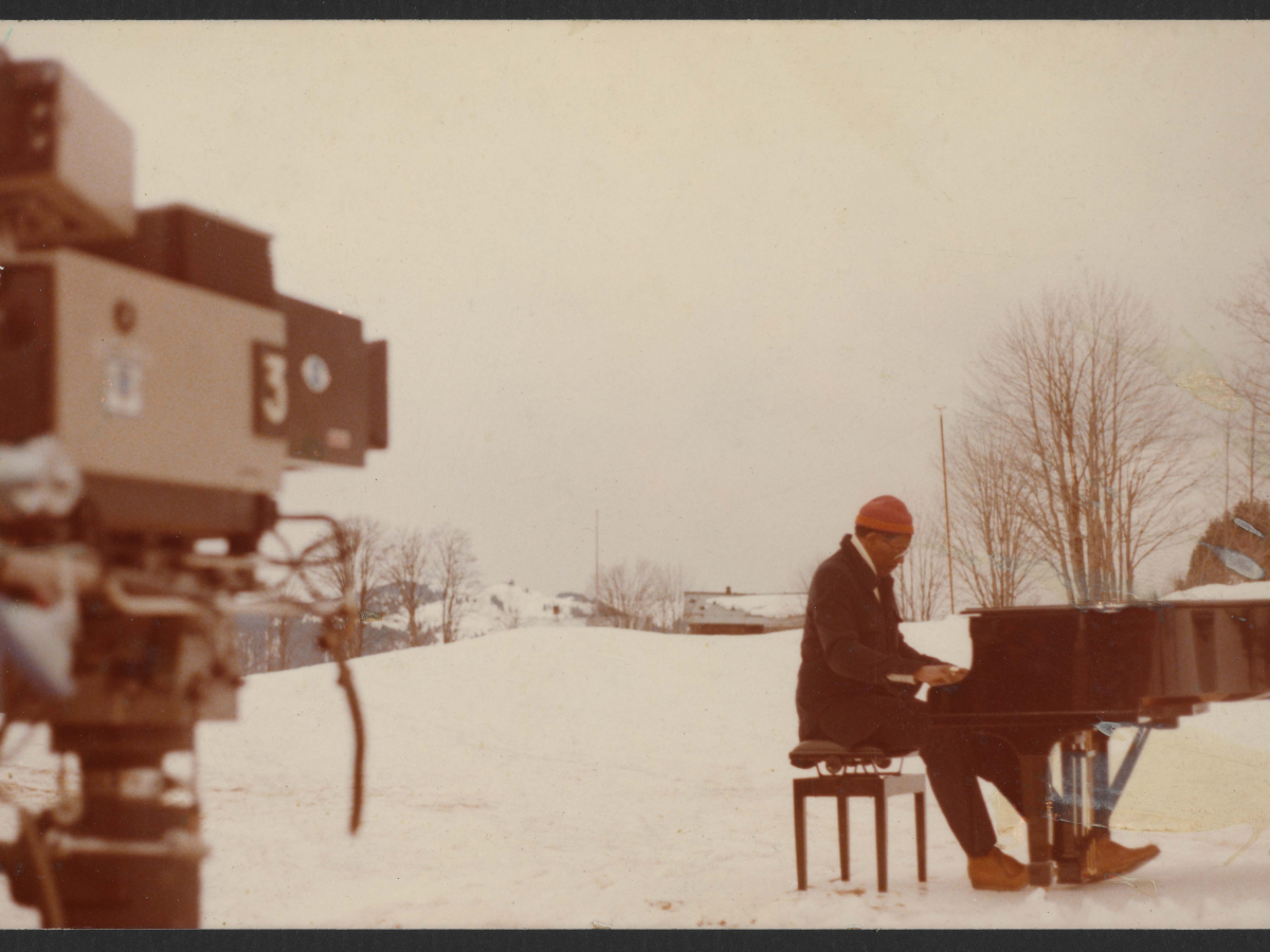 Pianist Randy Weston plays a grand piano in the snowy French Alps. 