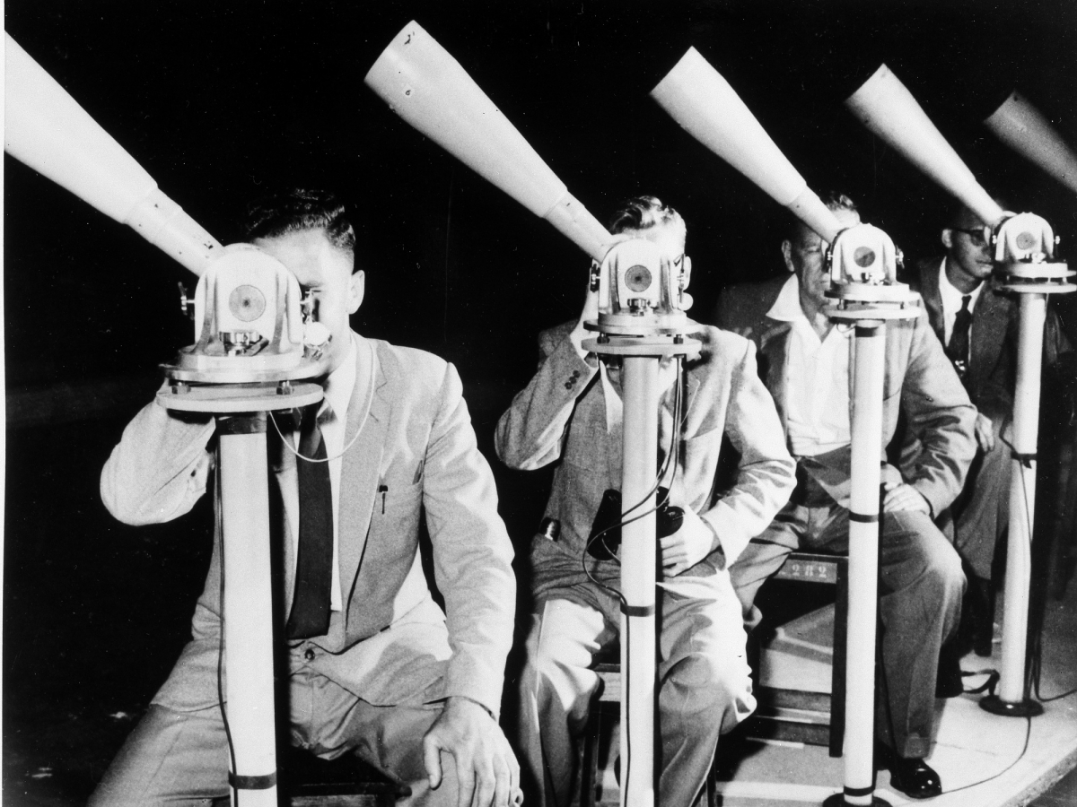 Moonwatch volunteers stationed at telescopes