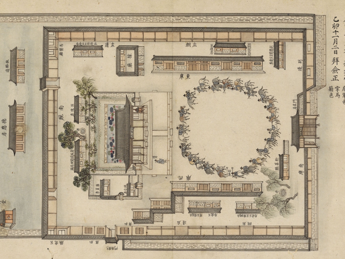 Horsemen ride in a circle in front of a large building surrounded by a stone wall.