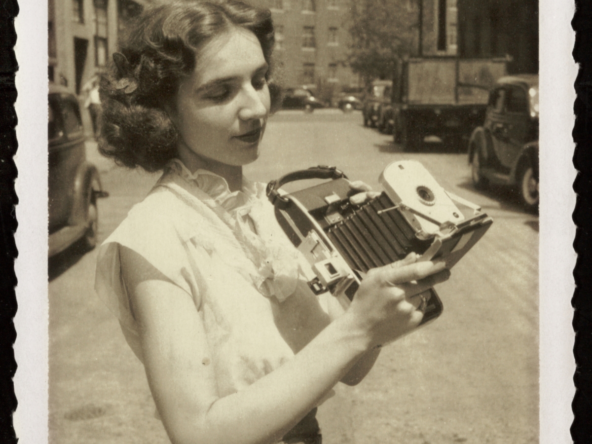 Woman standing outside with a camera