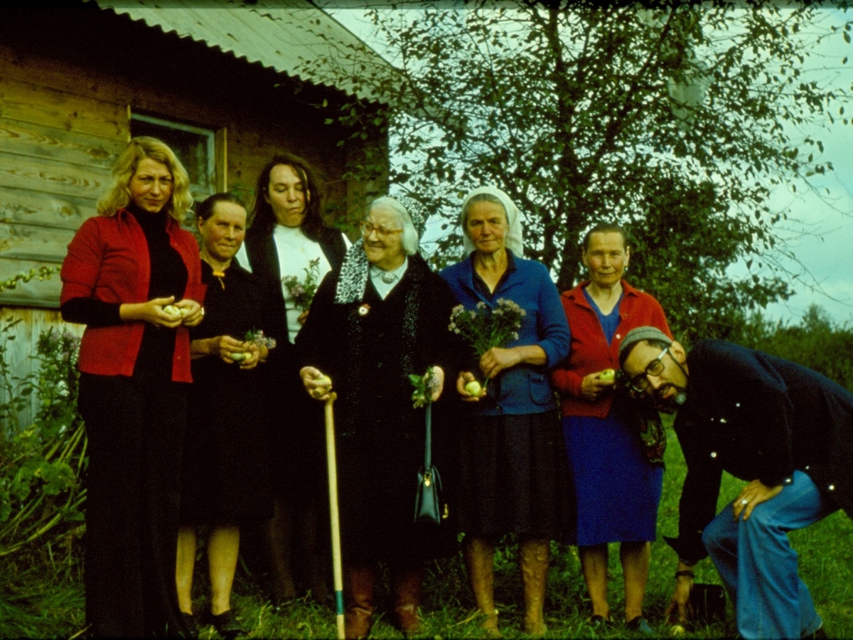 Siberian-born ethnomusicologist Eduard Alekseyev poses in front of a group of women holding a recording device