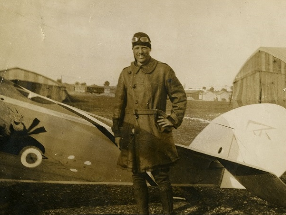Quentin Roosevelt stands in front of a military warplane
