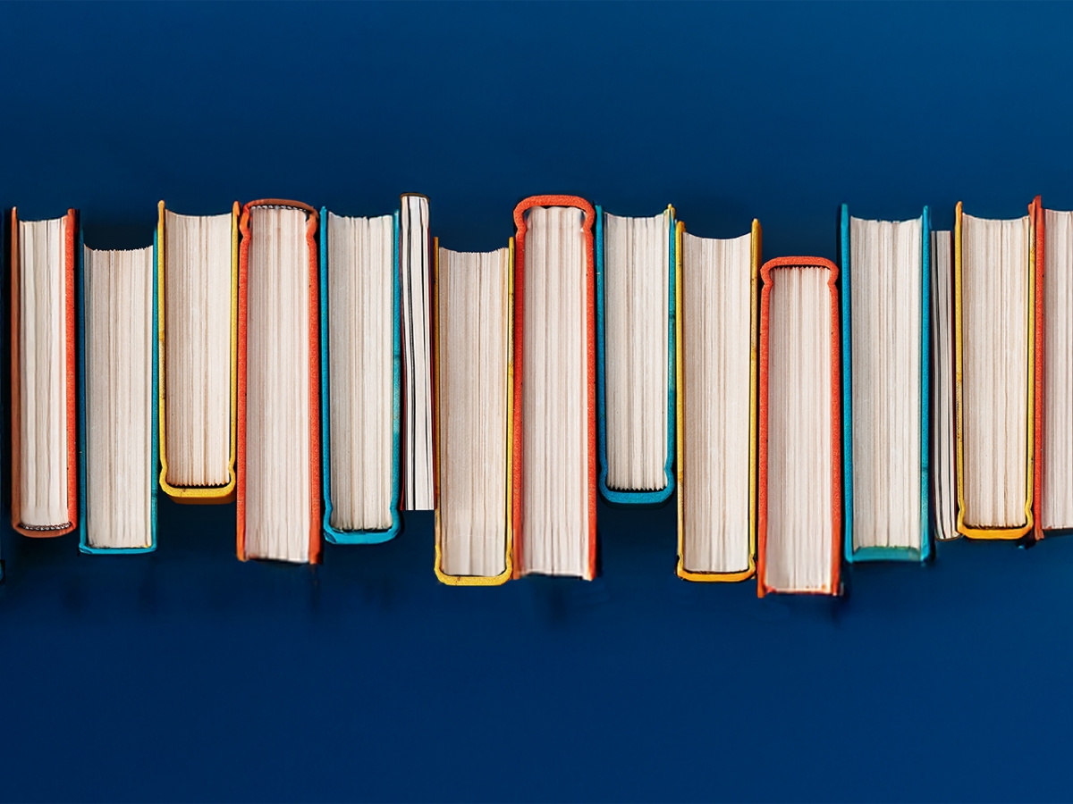 A row of books on a blue background
