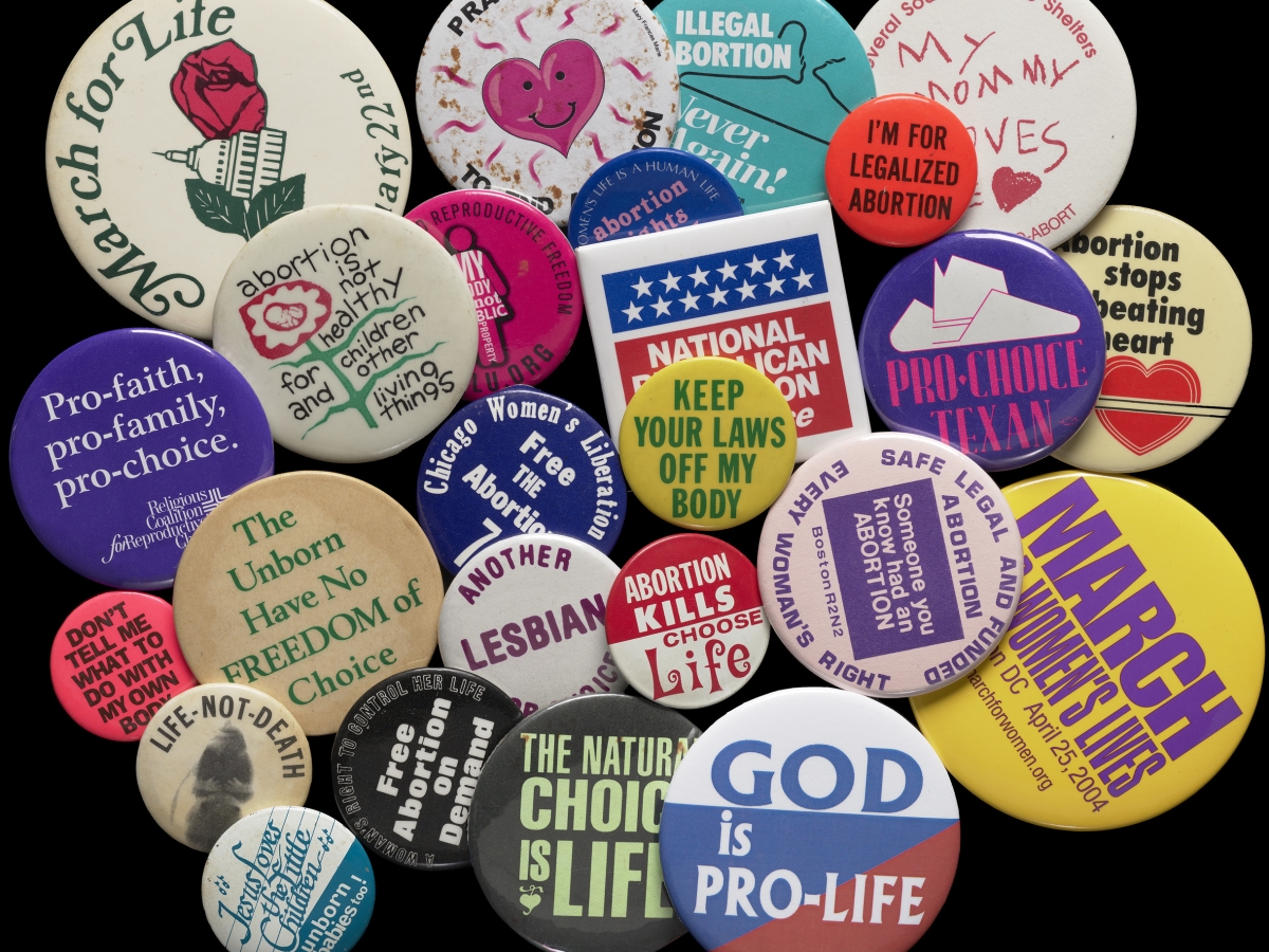 Multi-colored pro-choice and pro-life political buttons