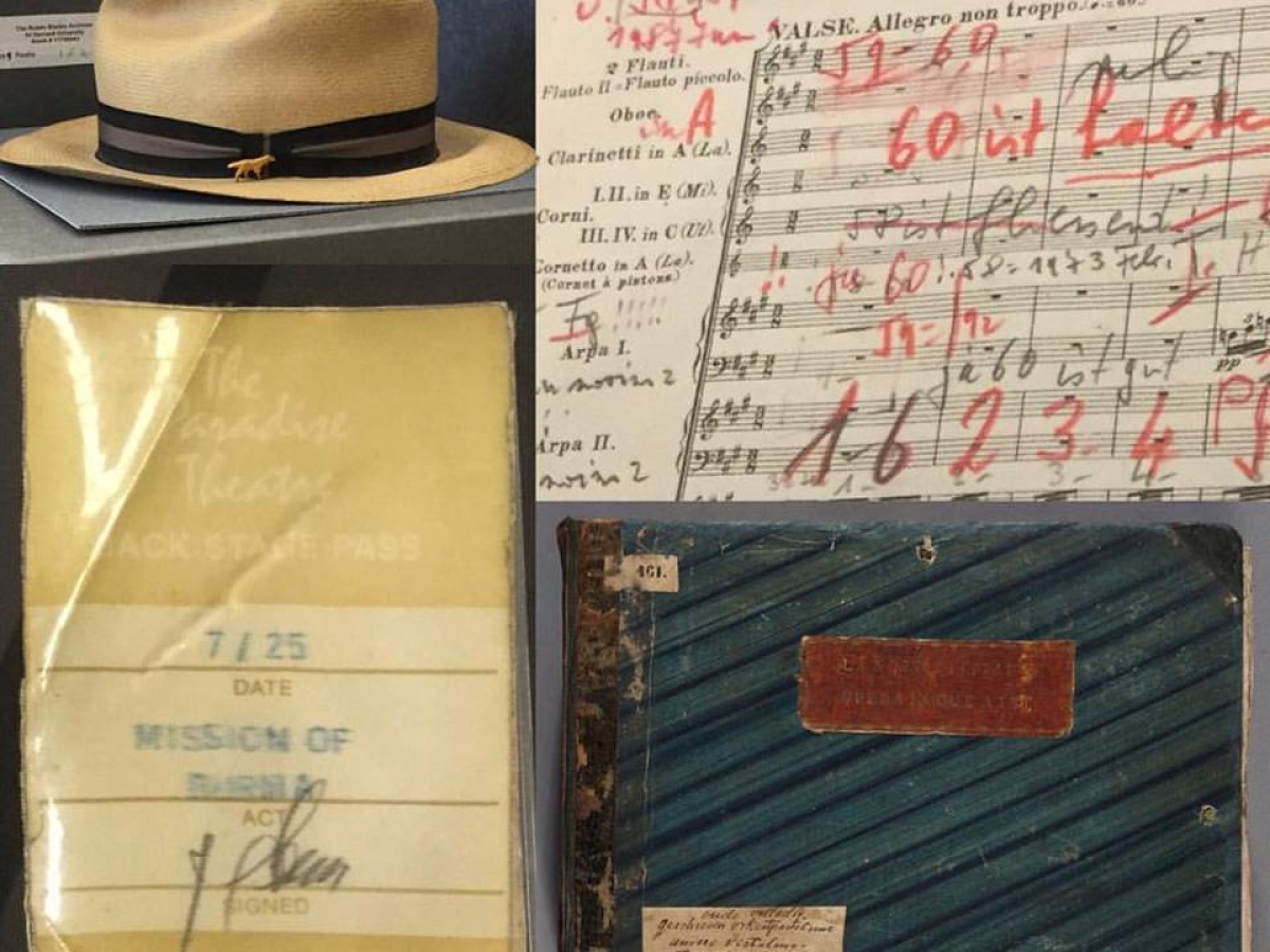 A montage of a straw hat, detail of a score heavily annotated in red pencil, a cassette tape, and a large oblong book bound in blue marbled covers.