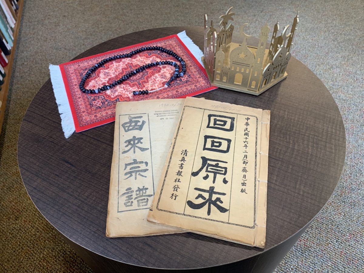 pamphlet, small prayer rug, and golden mosque model