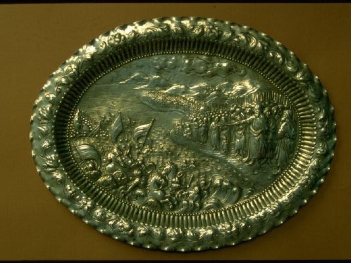 Metal seder plate depicting the parting of the Red Sea. 