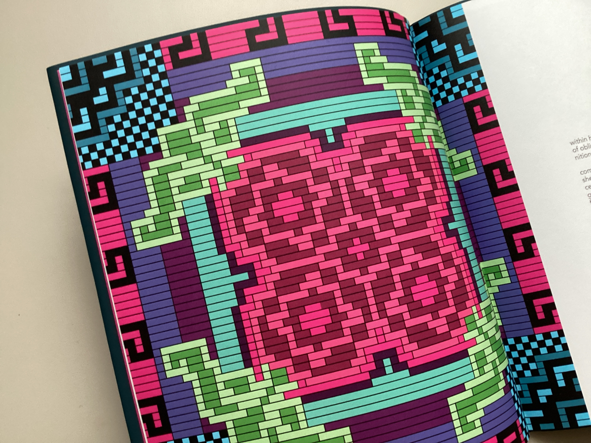Close-up of a page featuring a bright colored woven design