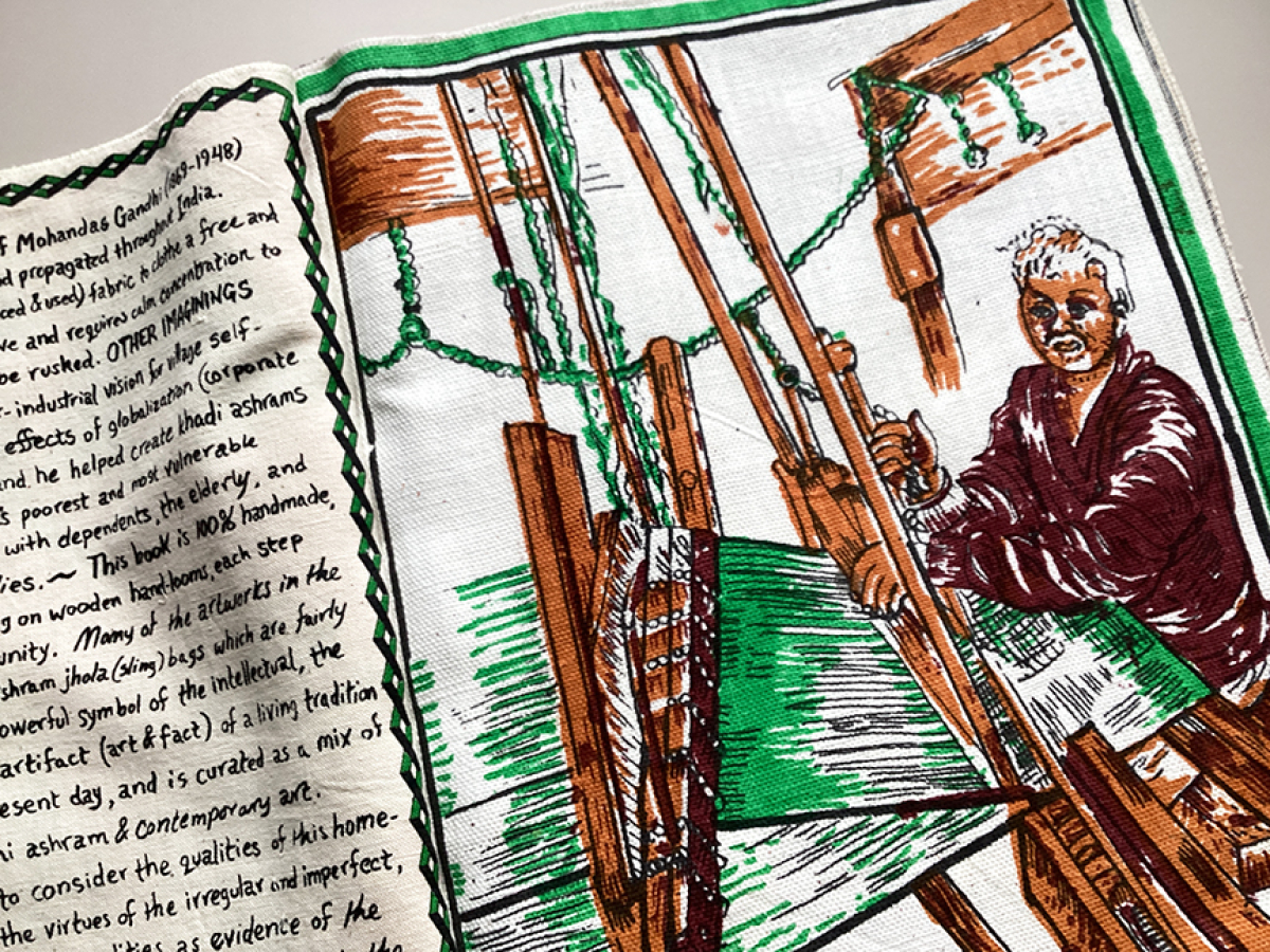 Close up of a drawing on fabric depicting a woman working on the loom