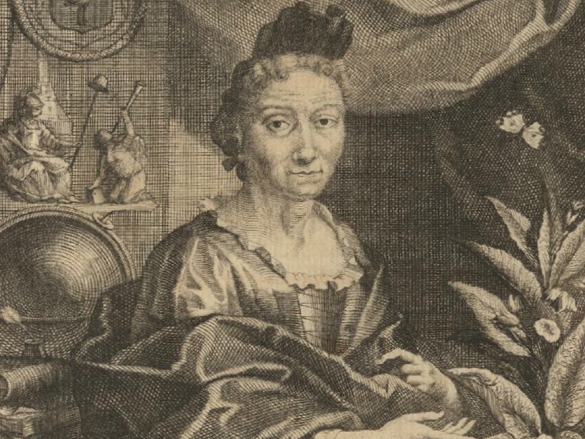 Woman wearing a satin gown and hairpiece sits in front of a globe and decorative figurines and next to a plant with a butterfly perched on it.