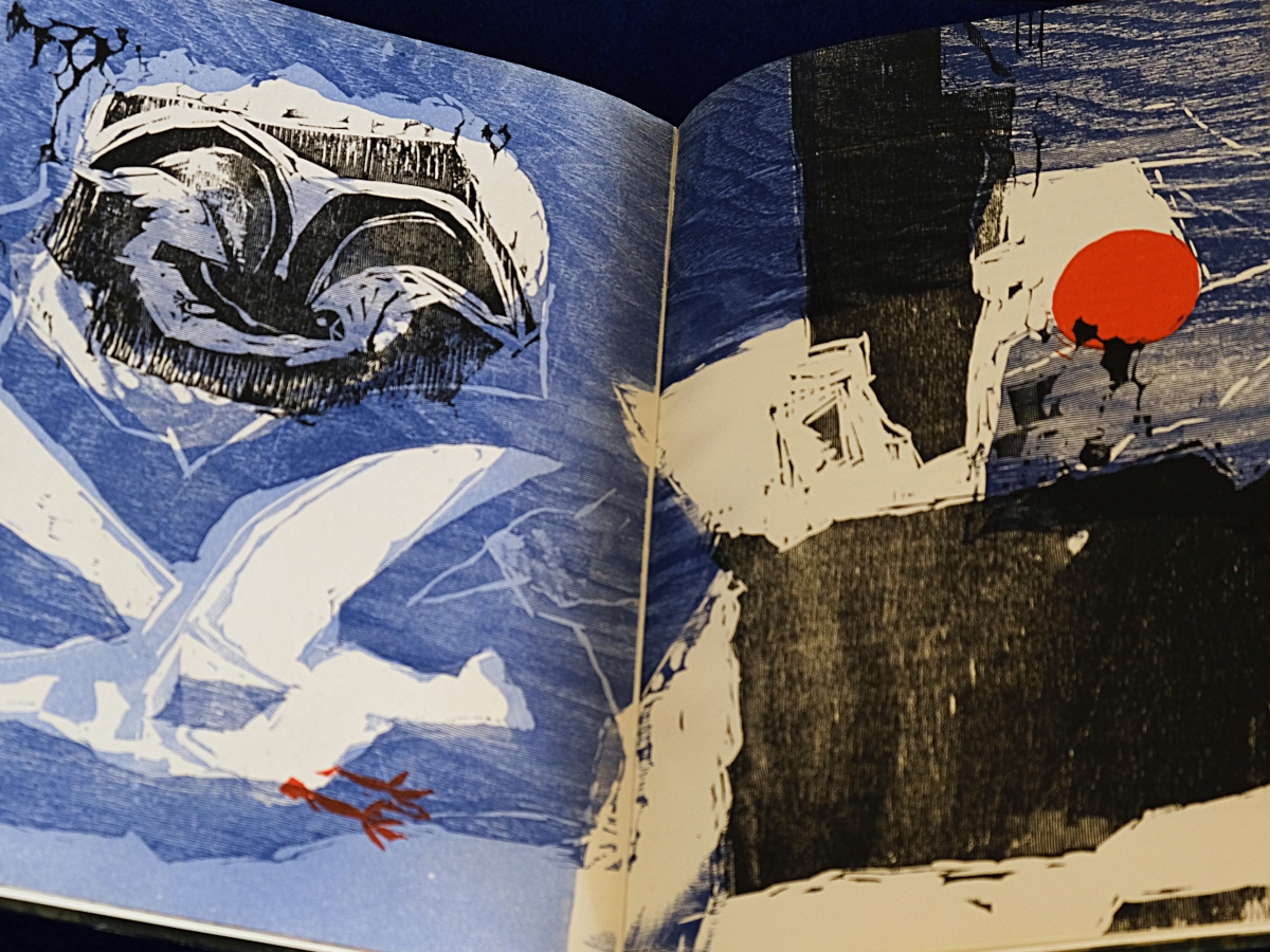 Page spread of woodblock illustrations. Left page shows two sea birds against the blue background. Right page shows blocks of black shapes against mostly blue background with a red circle above.