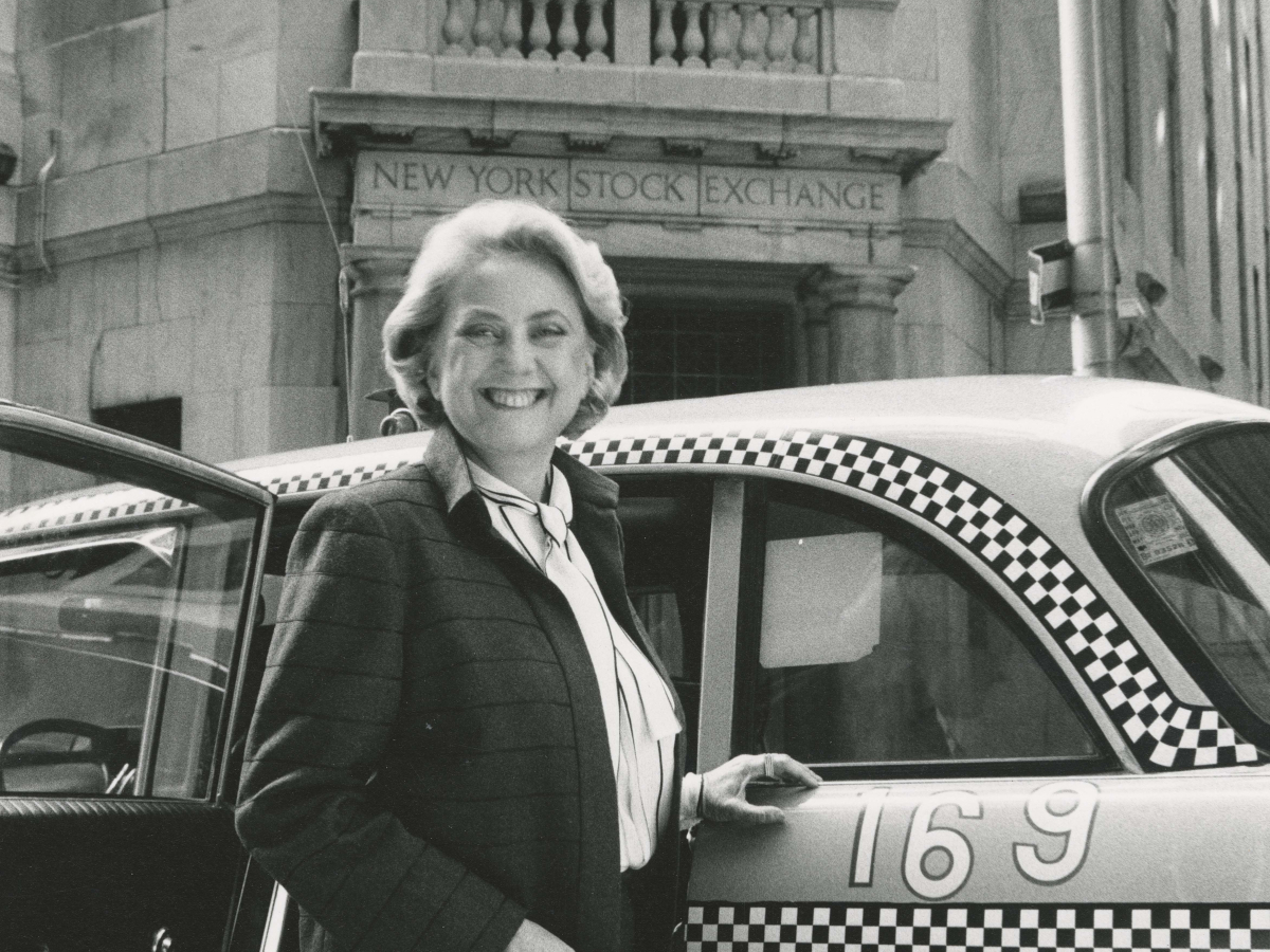 Muriel Siebert next to a tax outside the New York Stock Exchange