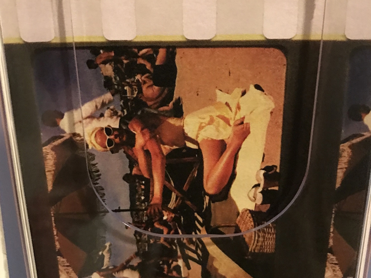 A holder with postcards featuring a frame from the film To Catch a Thief