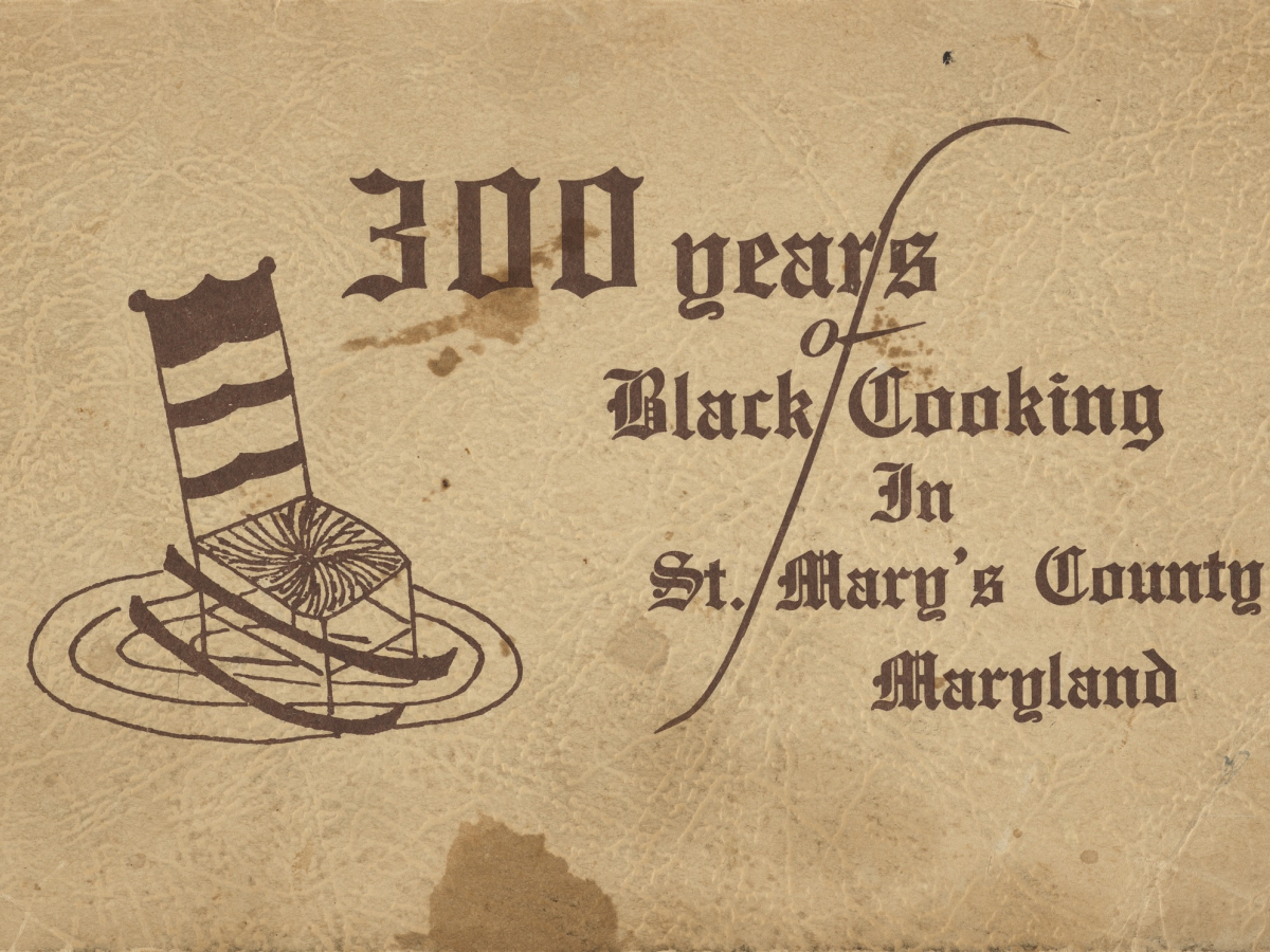 Cookbook cover on very stained beige paper with 300 years of Black cooking in St. Mary's County, Marlyand to the center and right. A drawing of a rocking chair on an oval rug is to the left of the text.