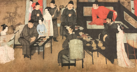 A facsimile of an East Asian painting scroll showing men and woman seated around tables and benches listening to a female musician play