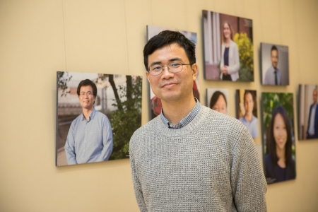  Junwei Lu, Assistant Professor of Biostatistics at the T.H. Chan School of Public Health, poses by his portrait.