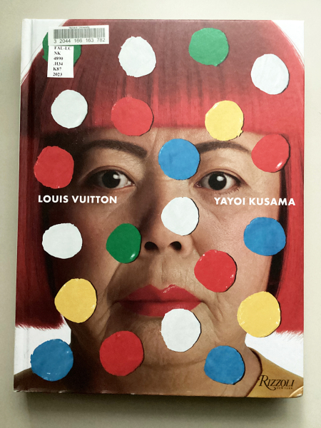 Book cover featuring a photo of Kusama with red hair wig with colorful dots over her face