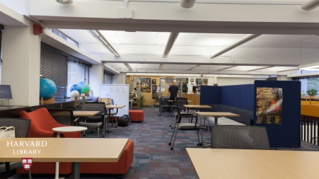 Photograph of a room with couches, desks and chairs 