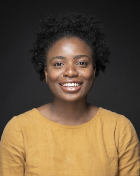 Ruva Chigwedere is wearing a yellow top and smiles at the camera