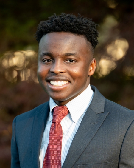 Nosa Lawani smiles, wearing a suit