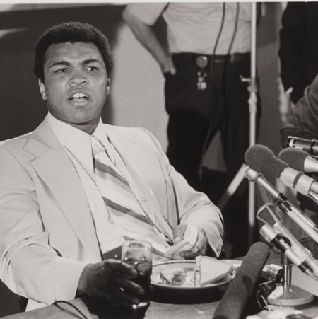 Muhammad Ali in front of microphones
