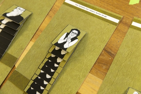 Strips of an art collage in lime green on a table.