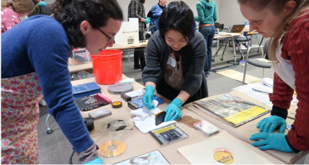 Preservation staff hold damaged A/V materials