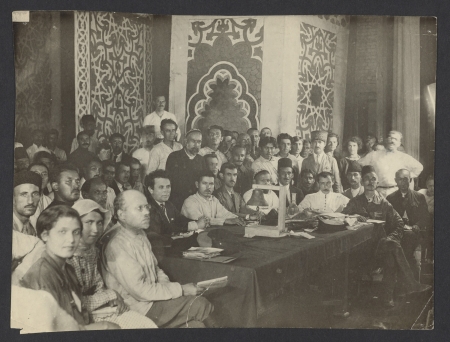 Large group of people seated before a table