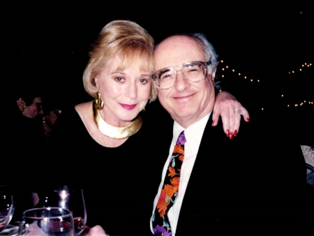 Nancy and Herbert Bernhard, in fancy dress, smile at the camera