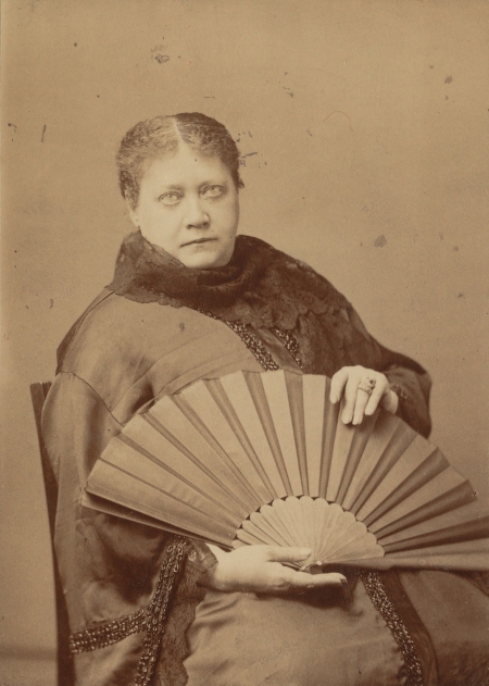 Photograph of Madame Blavatsky holding a fan, May 1887.