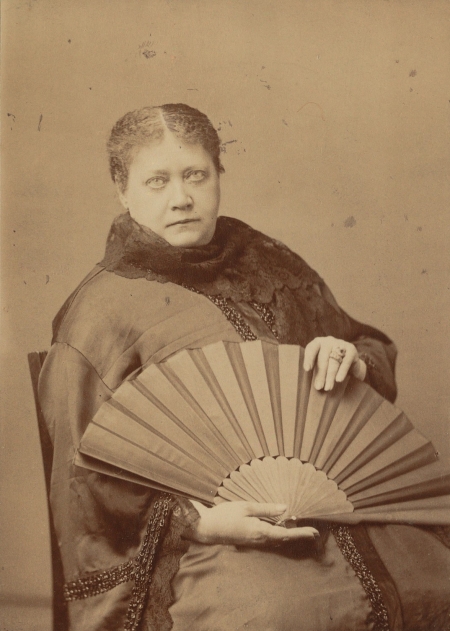 Photograph of Madame Blavatsky holding a fan, May 1887. 
