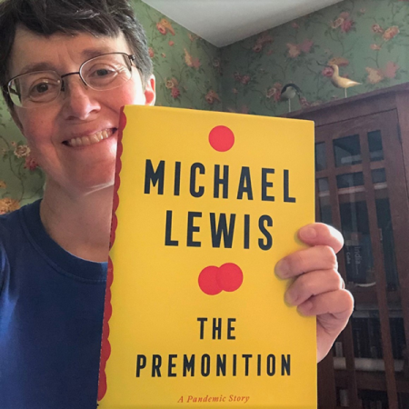 Photo of woman with book 'The Premonition'