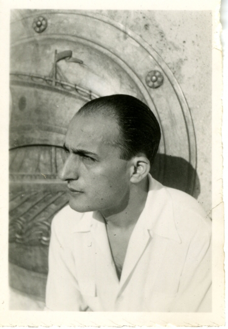 Nikos Gatsos, wearing a white top, looks away from the camera