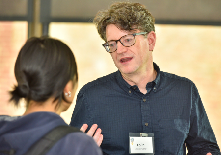 A librarian speaks to an event attendee.